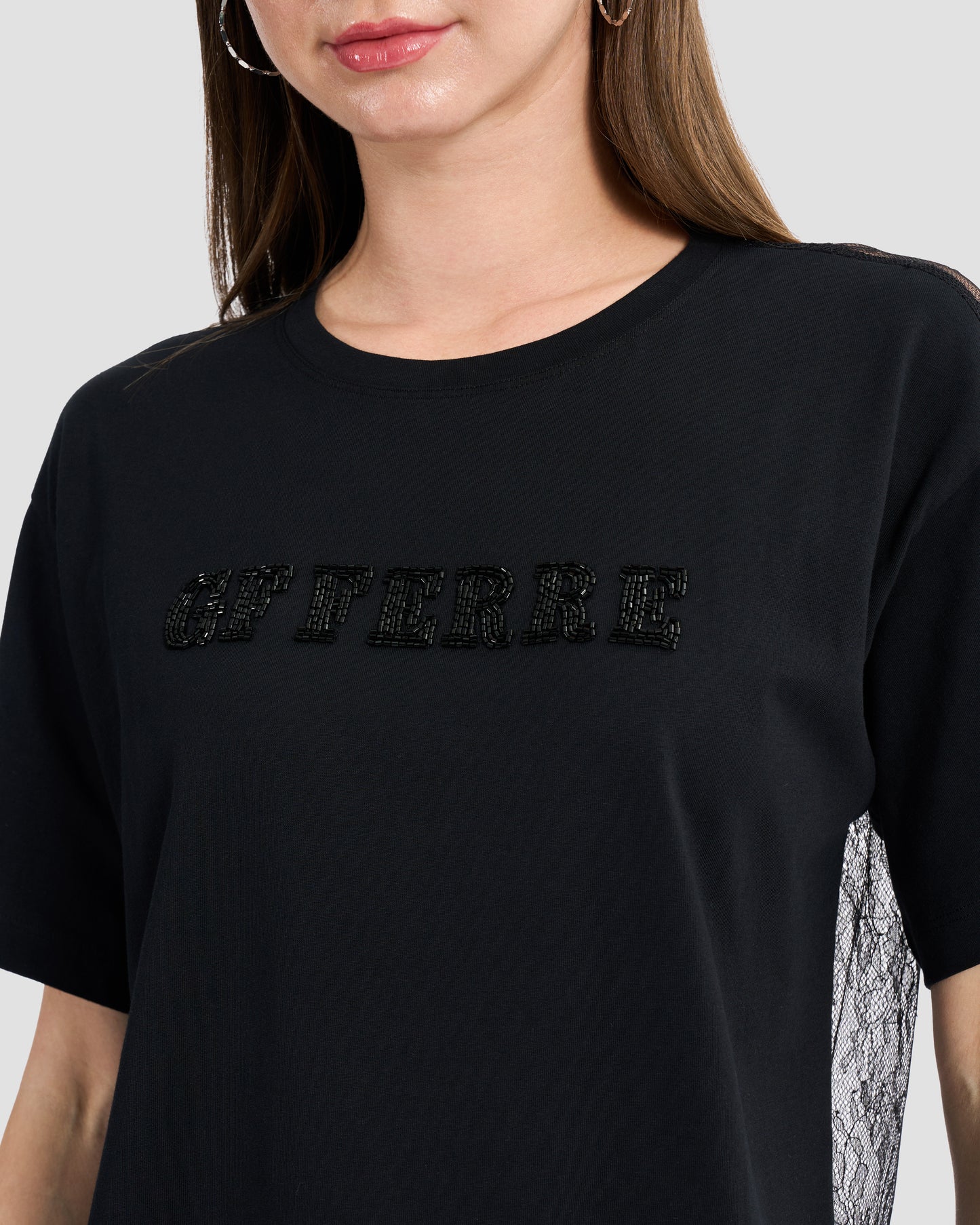 Round neck black t-shirt with lace back and finished off with a beaded Ferré to front.