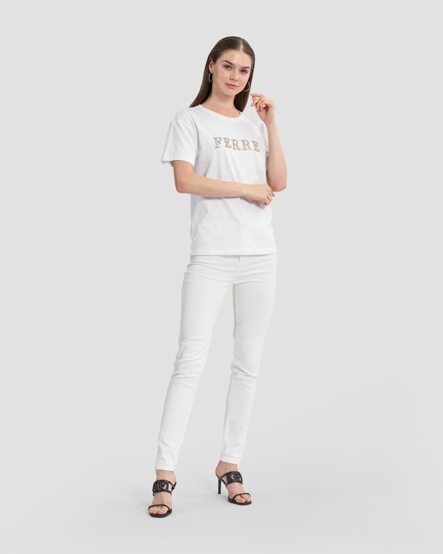 Round neck white t-shirt with rhinestones embellished Ferré branding to front.