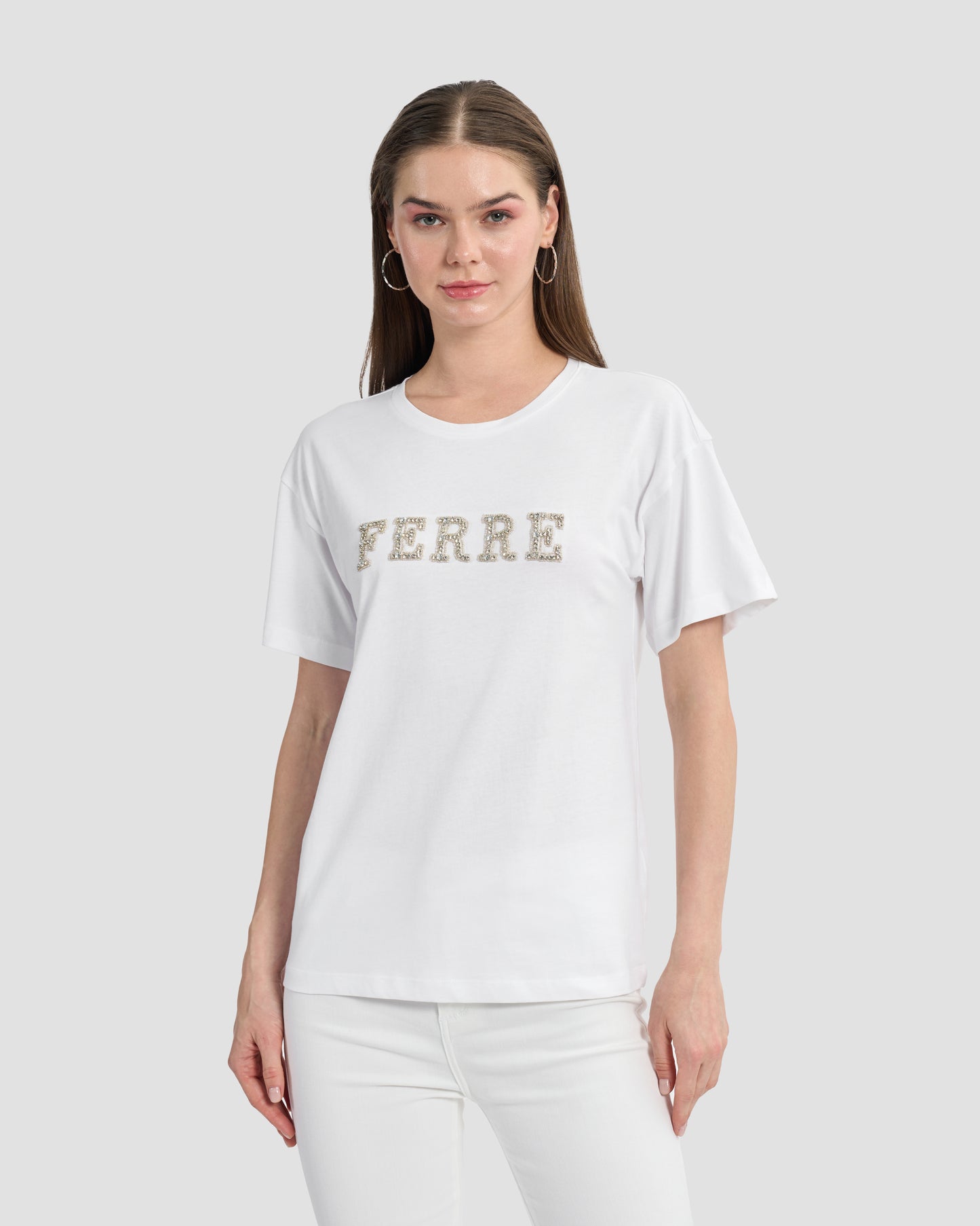 Round neck white t-shirt with rhinestones embellished Ferré branding to front.